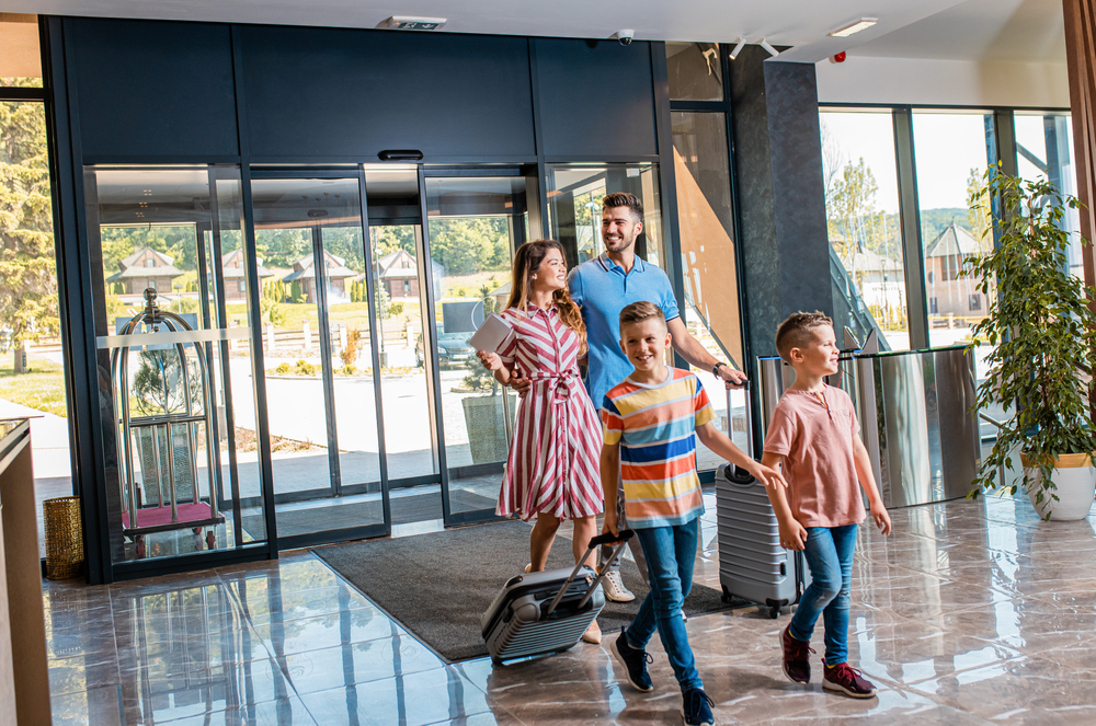 A family of four walks through a clean hotel lobby.