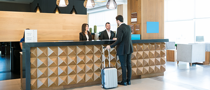 customer checking in at a front desk at a hotel